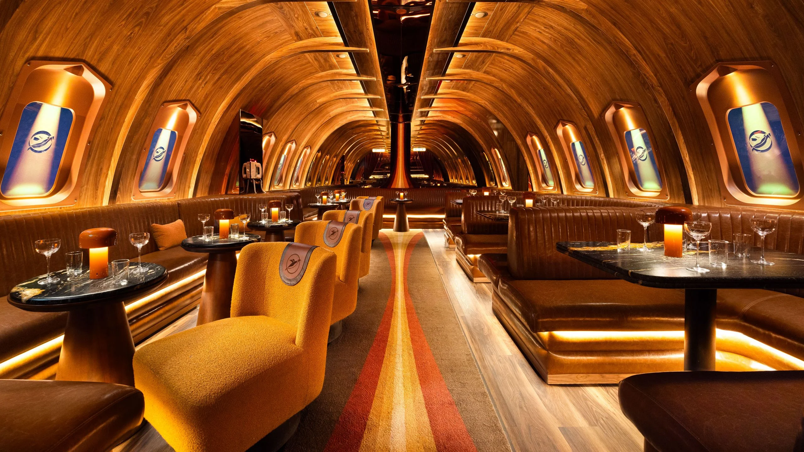 A wide view of a bar interior designed to resemble a modernist aircraft carrier.