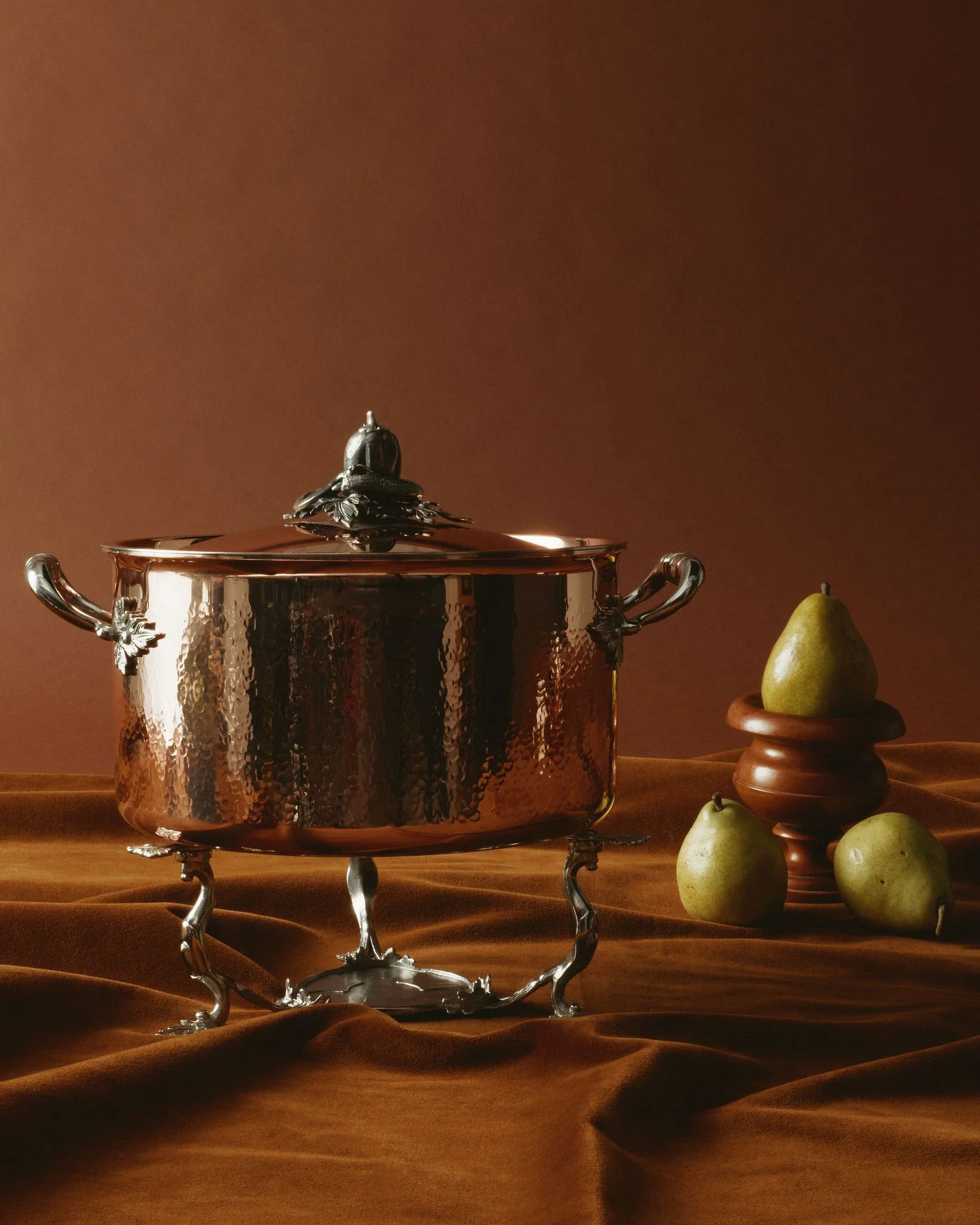 A Ruffoni copperbond chaffing dish and stack of pears.