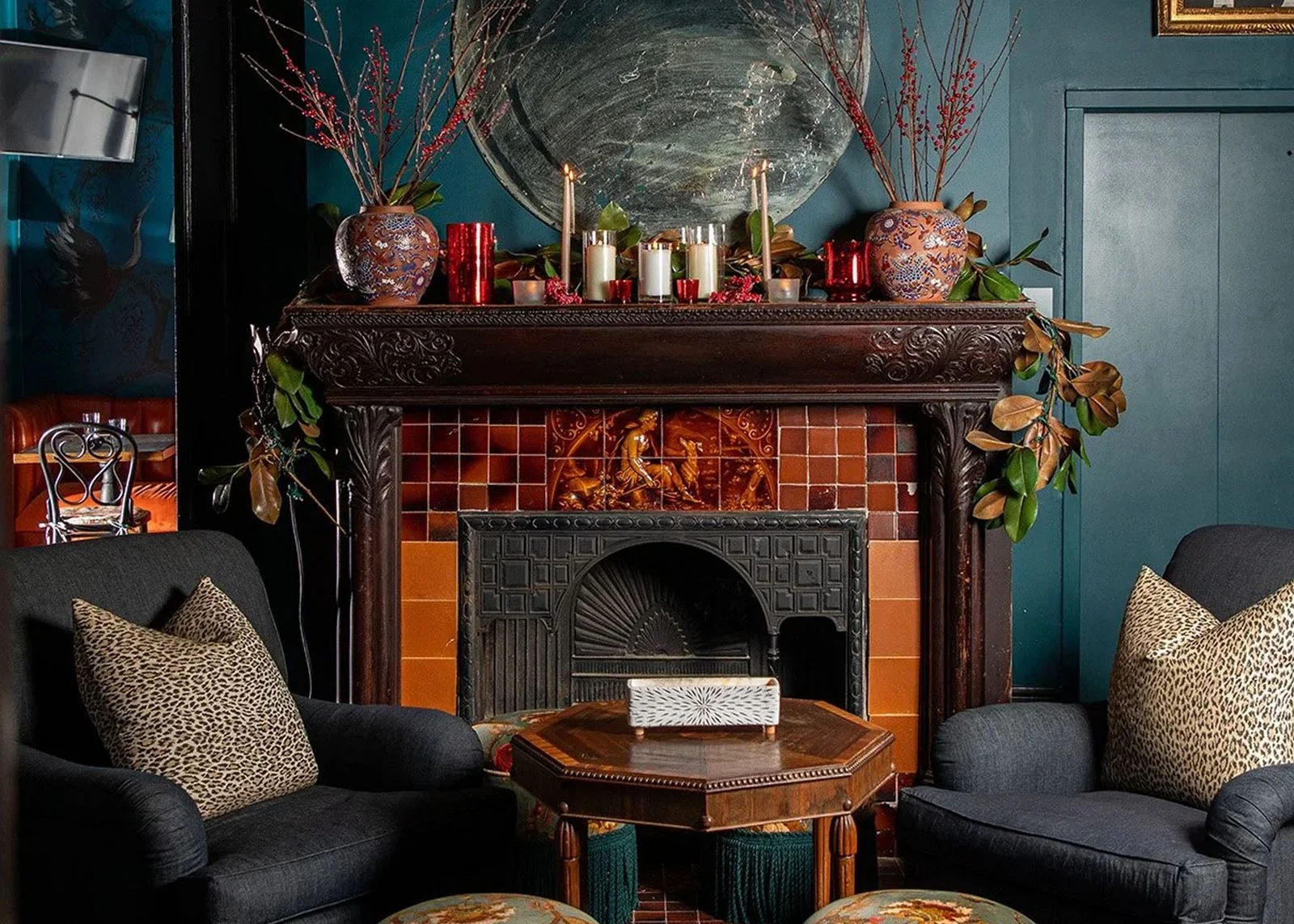 Image may contain Fireplace Indoors Hearth Adult Person Cup Furniture Table Architecture Building and Living Room