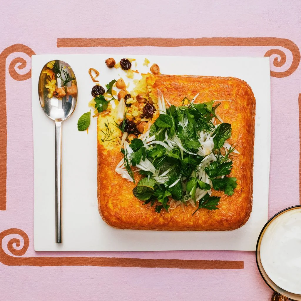herbytachinchickpeas on a white plate on a pink background