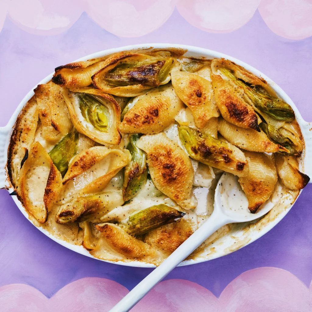Leaks and Baked pasta in a white dish on purple baking dish