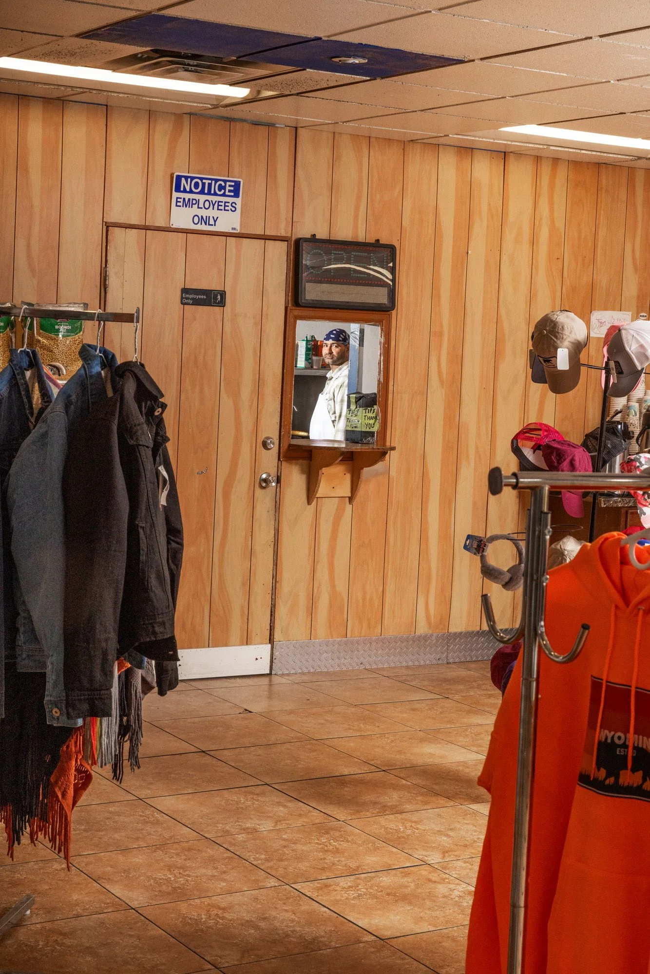 Image may contain Indoors Interior Design Wood Plywood Person Clothing Coat Hardwood Dressing Room and Room