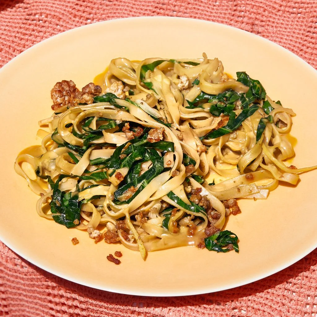 This image may contain Furniture Dining Table Table Plant Food Pasta Produce Spaghetti Noodle and Vegetable