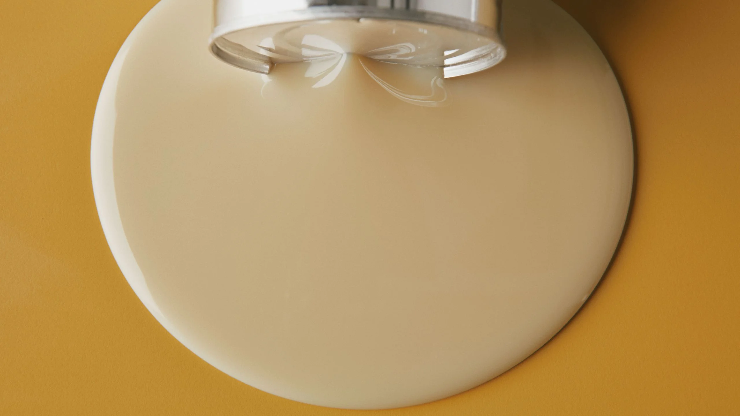 Sweetened condensed milk leaking out of a can.